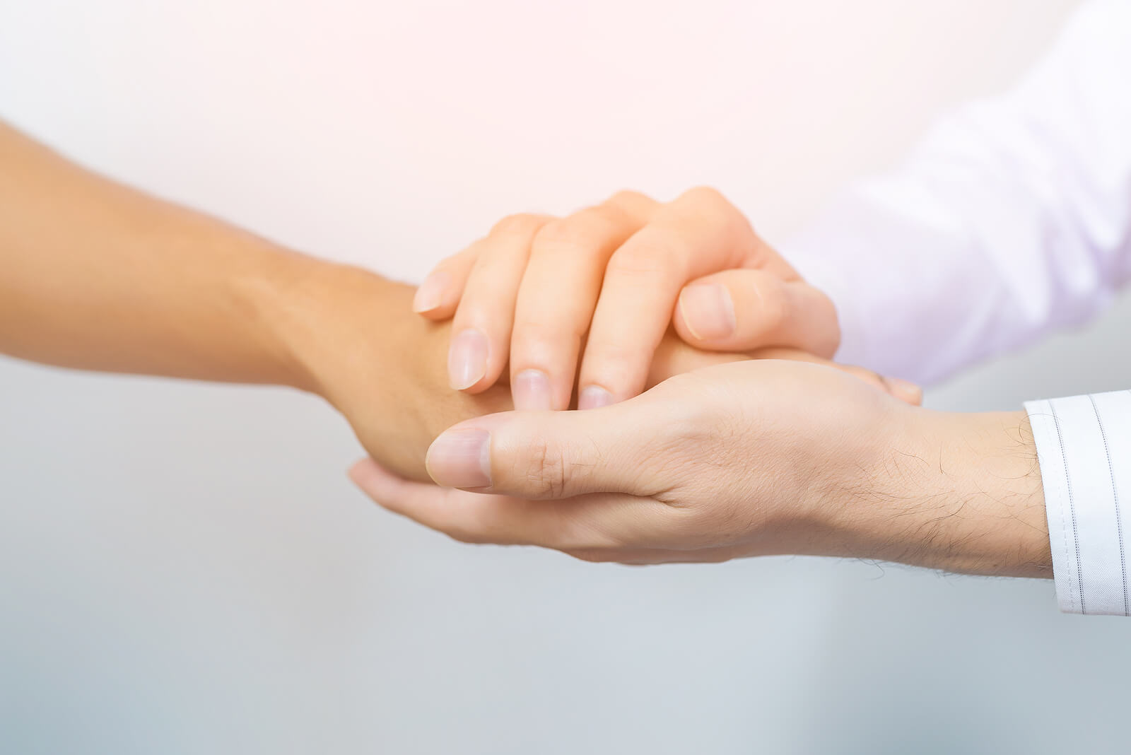 People holding hands supporting each other. PTSD treatment does not have to be scary. Our online PTSD therapist in Ohio is here to gently guide you through the process.