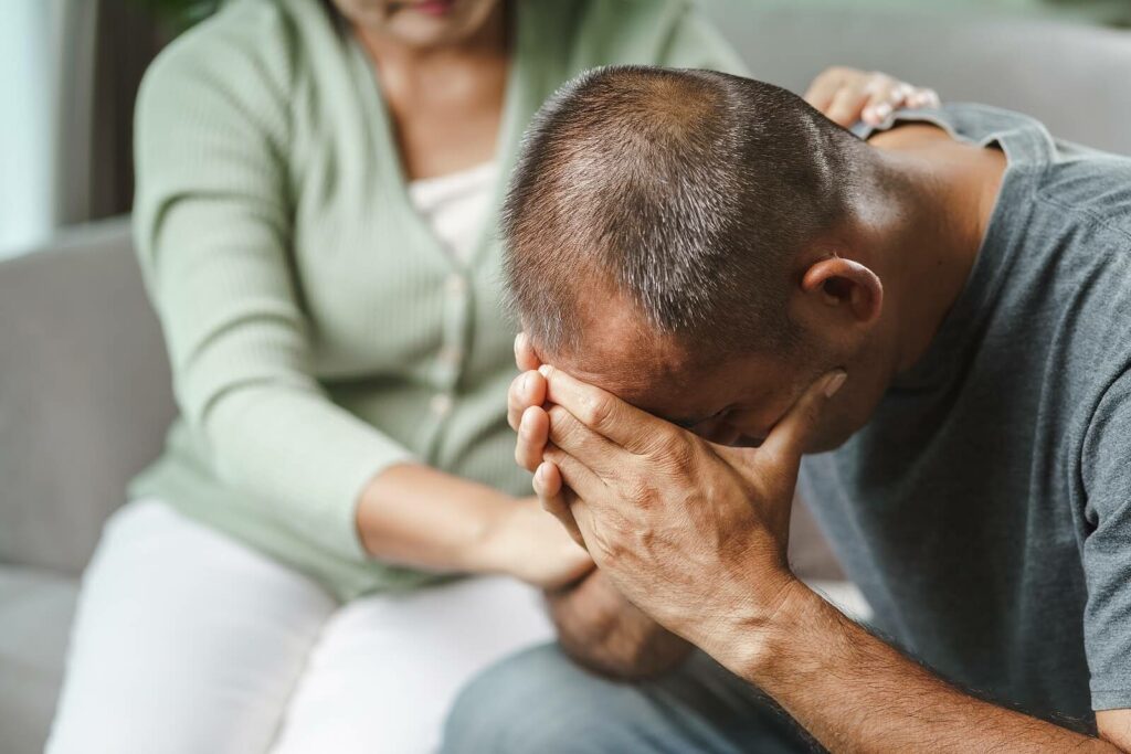 Asian man struggling to overcome the symptomms of PTSD through representing the importance of PTSD treatment with a PTSD therapist. Learn more here.