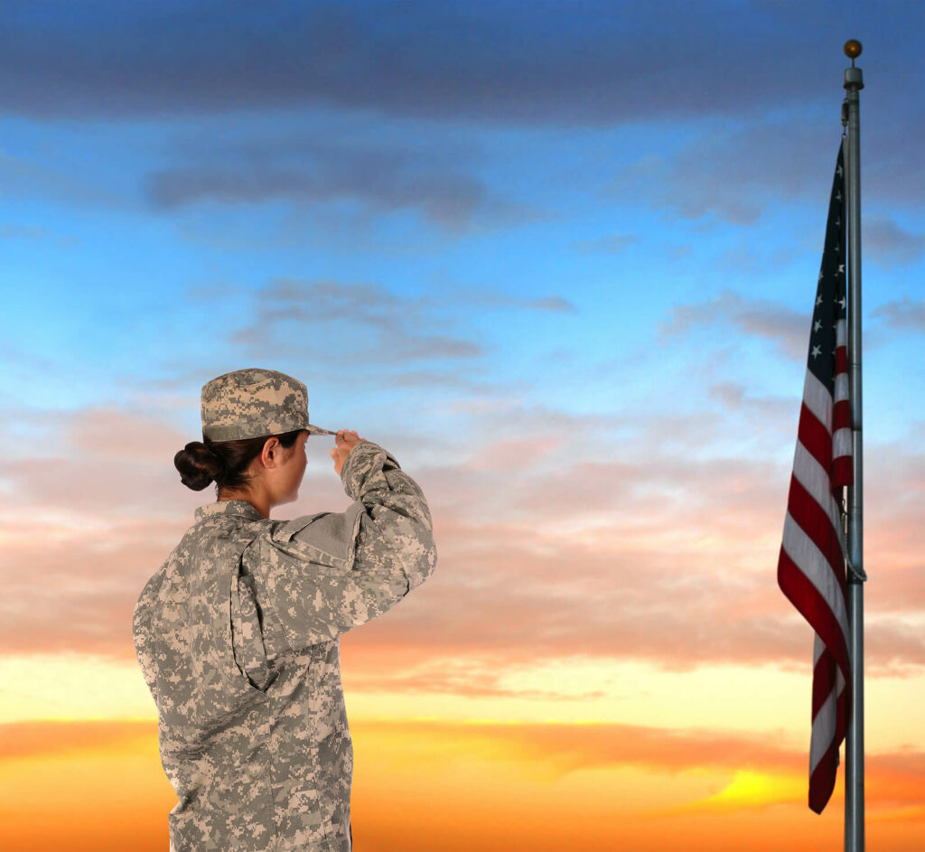 Hopeful combat vet saluting the American flag. PTSD symptoms impact a huge number of combat verterans and PTSD treatment is available in Ohio to help you overcome the symptoms of PTSD.