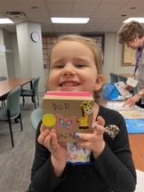 Young girl holding a craft she completed at Fernside while learning to process her grief. Online Therapy in Ohio can also be a resource when faced with unexpected trauma. 