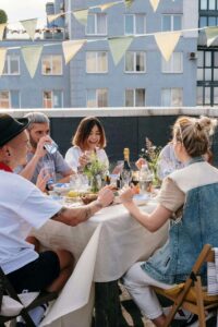 A group of friends laughs and connects over a rooftop meal, reflecting the importance of support for a sexual assault survivor in Ohio, finding a therapist for sexual trauma in Ohio, and exploring sexual assault therapy near me. 