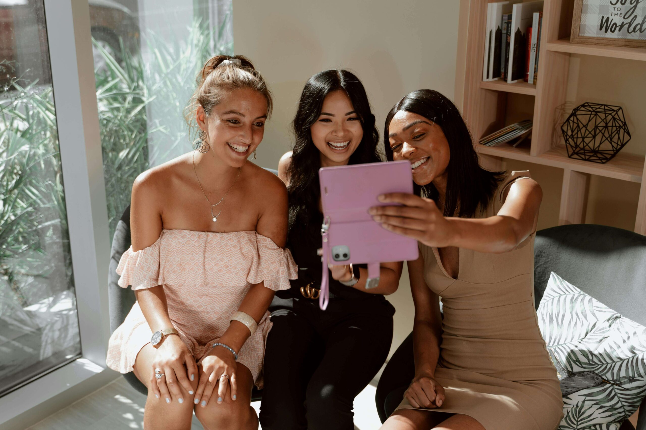 Three women smiling and taking a selfie together after a support group session for therapy for childhood trauma survivors and sexual assault survivors in Ohio, guided by a therapist for sexual trauma in Ohio.